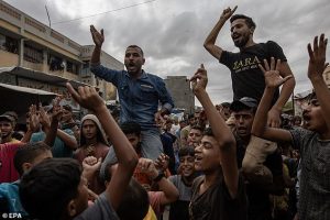 Pictured: Palestinians celebrate the announcement of a ceasefire agreement between Hamas and Israel in Khan Younis, southern Gaza Strip, on Thursday