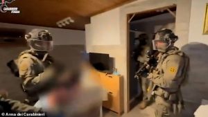 Leonardo Gesualdo was dragged out of bed by police and is shown in footage being held by officers