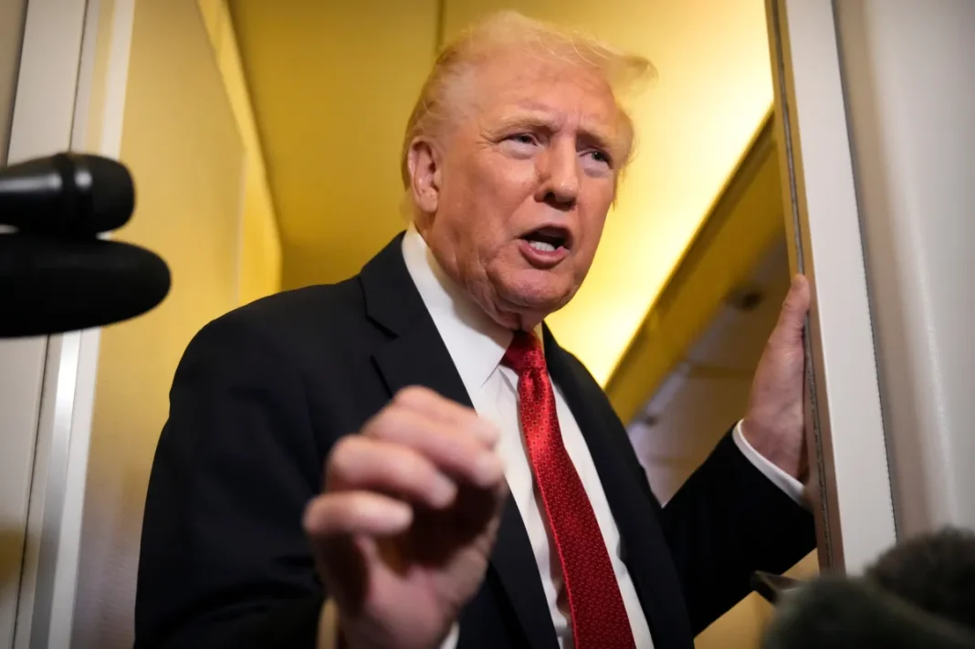 US President Donald Trump speaks to reporters aboard Air Force One.