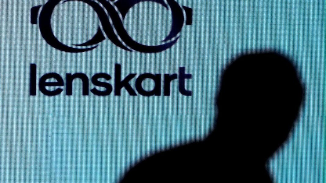 A man walks past a logo of Lenskart, an Indian multinational eyewear company before the announcement of its IPO in Mumbai, on October 27, 2025. | Photo Credit: Reuters