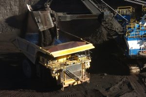 A mechanized shovel loads coal into a haul truck at the Spring Creek mine. (Photo by AP)
