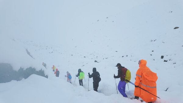A screen capture from video shows trekkers leaving their campsite, as unusually heavy snow and rainfall pummeled the Himalayas, in the Tibet Region