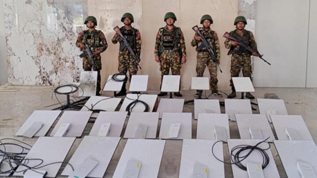 In this image provided by the Myanmar military on Oct. 19, 2025, soldiers stand next to Starlink machines as they seize KK Park online scam center in Myawaddy township, Karen State, Myanmar. Photo: The Myanmar Military True News Information Team via AP