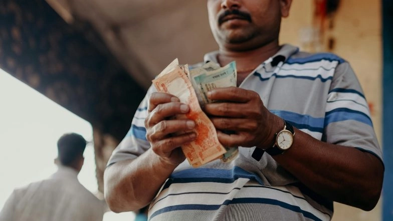 Money Laundering, Scammer, Fraudster| Representational image of Person Counting Cash (Photo Credits: Pexels)