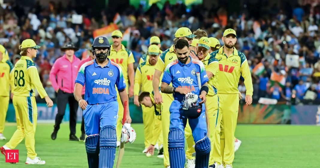 Virat Kohli, Rohit Sharma and players of Australia walk off the field after game three of the One Day International series between Australia and India