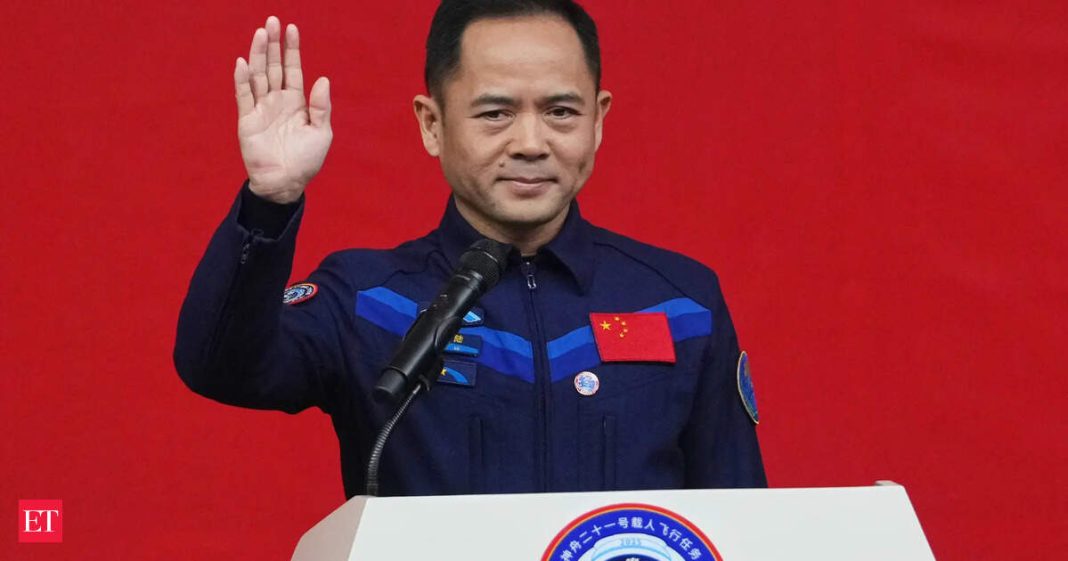Astronaut for the upcoming Shenzhou 21 mission Zhang Lu waves during a meeting with the press at the Jiuquan Satellite Launch Center in Jiuquan, northwest China, Thursday, Oct. 30, 2025. (AP Photo/Andy Wong)