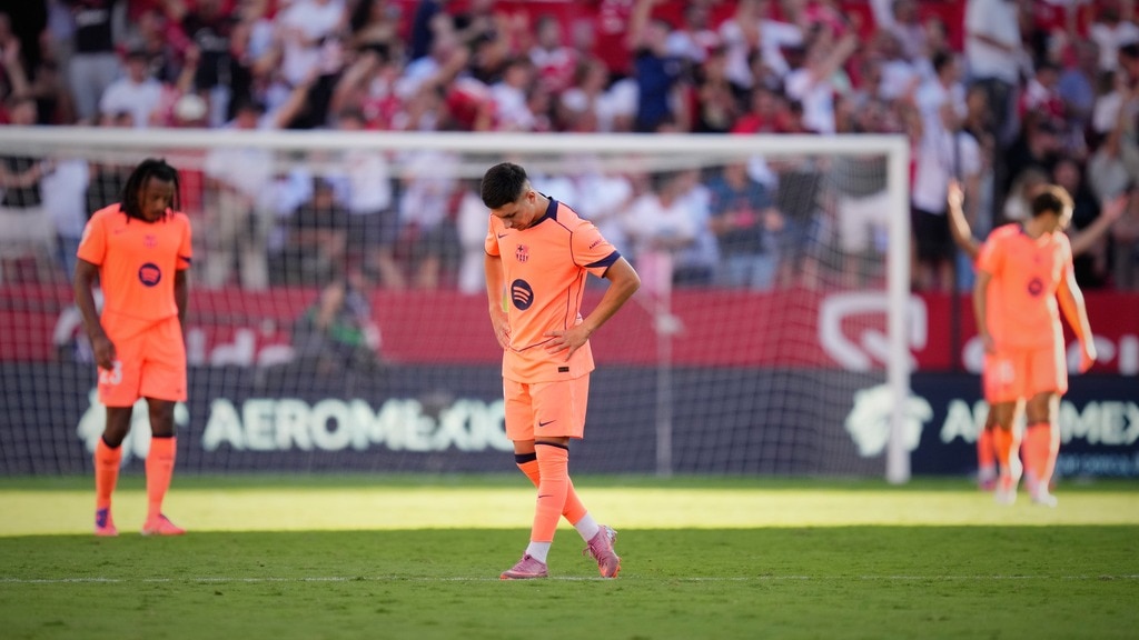 Barcelona players look dejected after defeat to Sevilla. (AP Photo)