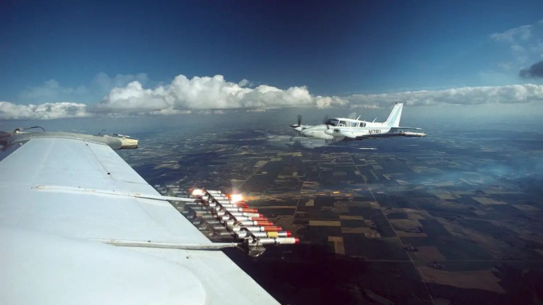 Cloud seeding equipment on the wing of a plane | X