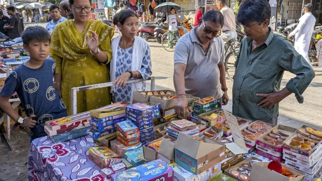 People shop for firecrackers at a roadside during the Diwali festival.