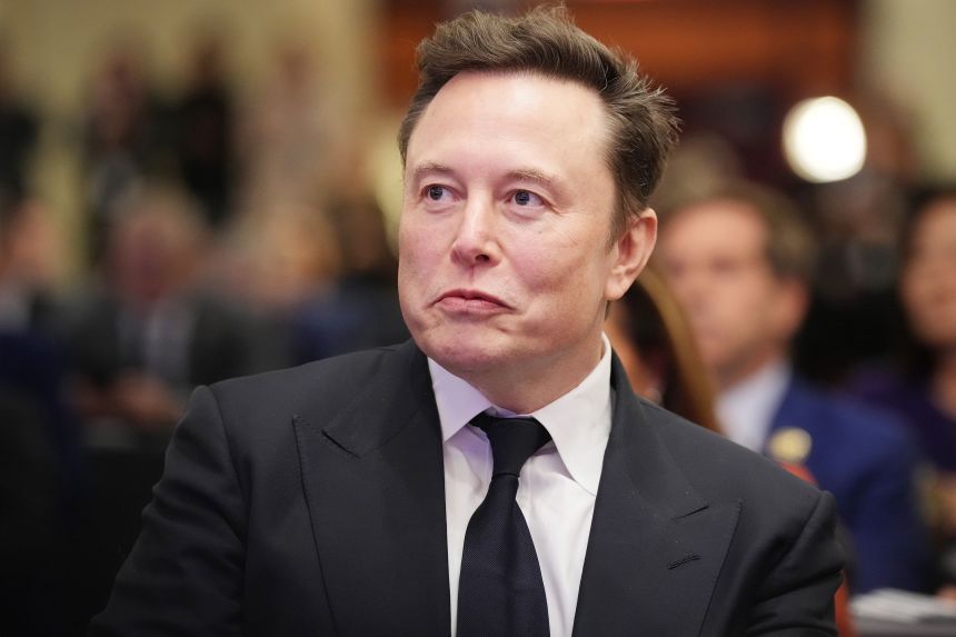 Elon Musk listens as then-President-elect Donald Trump addresses a House Republicans Conference meeting at the Hyatt Regency on Capitol Hill on November 13, 2024 in Washington, DC.