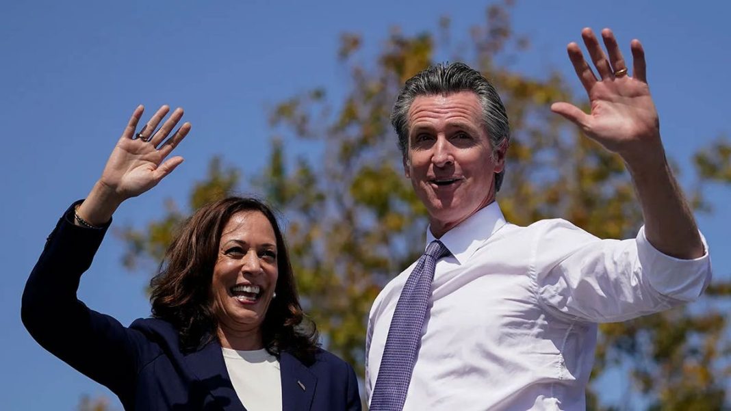 Vice President Kamala Harris stands on stage with California Gov. Gavin Newsom at a campaign event in San Leandro, California, Sept. 8, 2021.