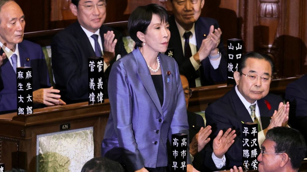 Leader of Japan's ruling Liberal Democratic Party (LDP) Sanae Takaichi reacts as she receives applause after being elected as prime minister, at the Lower House of Parliament in Tokyo, Japan | REUTERS
