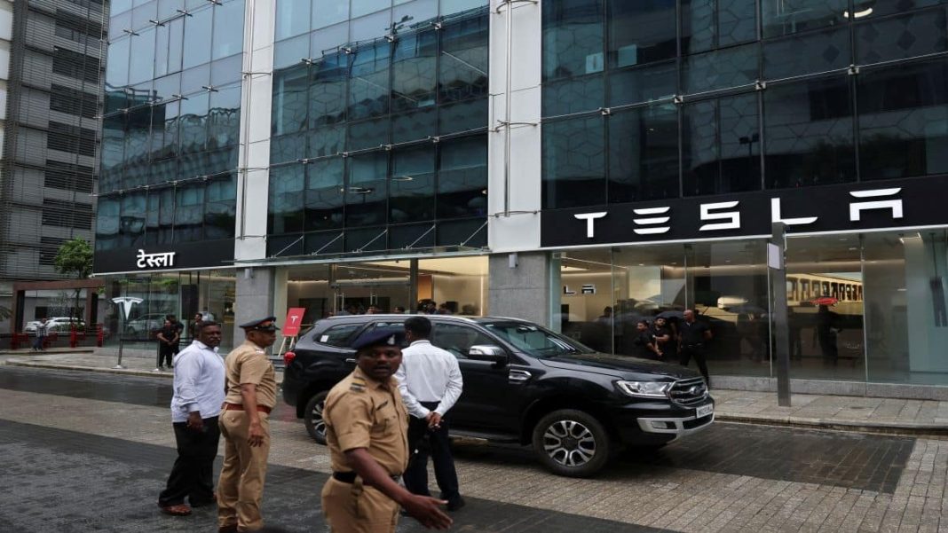 Police officers direct traffic outside the Tesla showroom ahead of its opening in Mumbai. Reuters file