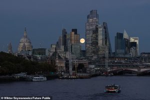 A supermoon rising over London's skyline last year. These moons appear larger as their orbit is closer to the Earth than usual