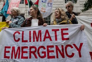 Climate protesters demonstrate outside London's Department of Energy Security and Net Zero, however, Lindzen said net zero policies will only prevent a tiny amount of warming