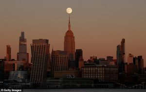 The Beaver moon rose behind the Empire State Building as the sun set in New York City yesterday