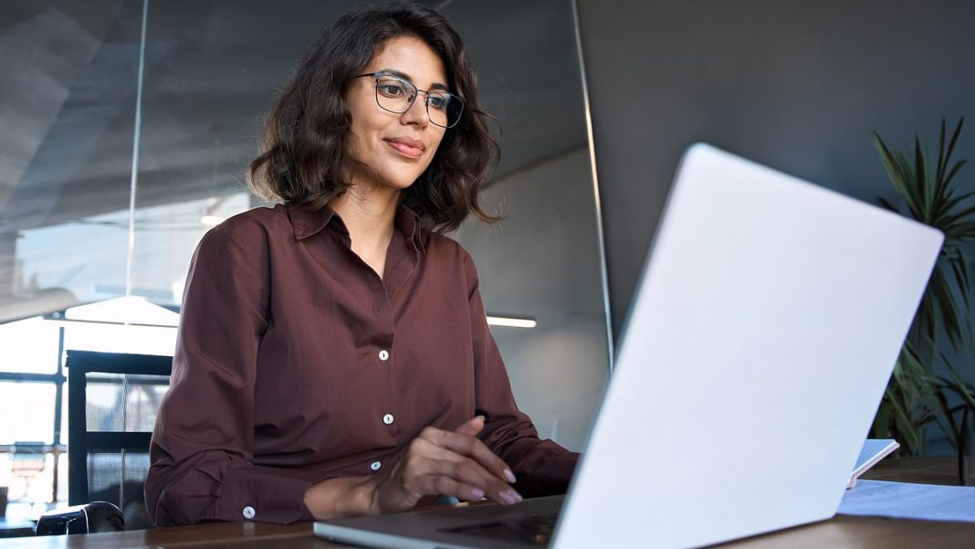 An experiment which has been rerun has found the female applicant was ranked as marginally more capable and appealing to work with (stock image of a woman in front of a computer)