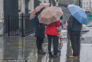 Scientists' climate models predicted that the UK would see more rain over the winter months, but underestimated just how fast these changes would come about, leaving the UK at risk of flooding. Pictured: Pedestrians in London take shelter during Storm Claudia