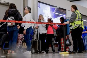 Passengers wait in a long line to rebook their canceled flights at Hartsfield-Jackson Atlanta International Airport. America's busiest airport has been snarled by delays on Tuesday (Stock Image)