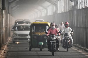 Commuters ride along a bridge across the Yamuna river in New Delhi on Oct. 21 as smog engulfed the city a day after Diwali. Arun Sankar / AFP via Getty Images