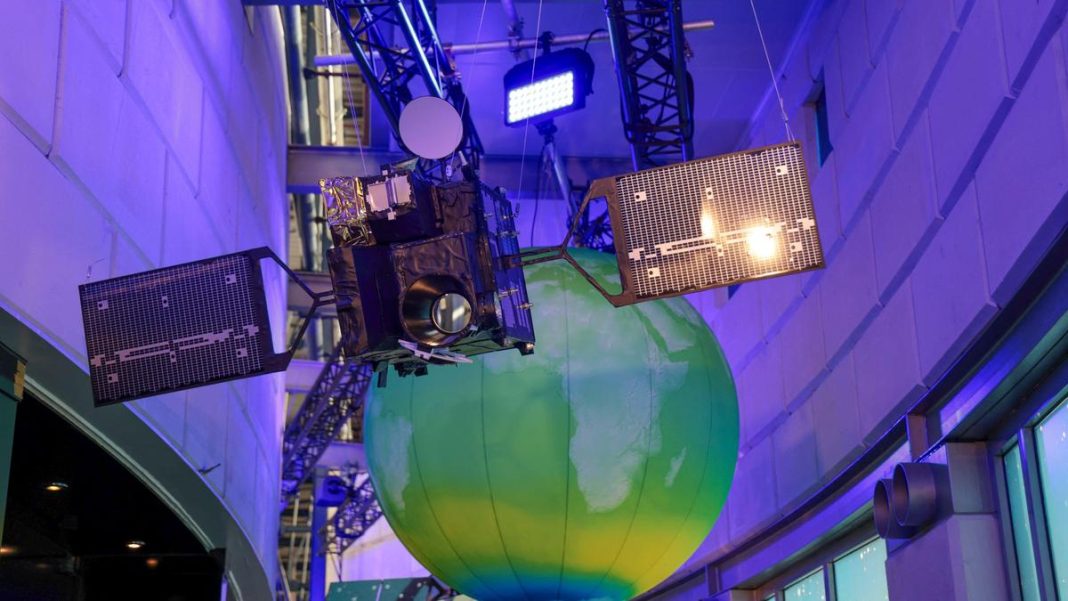 A satellite model hangs from the ceiling during the European Space Agency (ESA) ministerial meeting at the Congress Centrum in Bremen, Germany, on November 26, 2025. | Photo Credit: AFP