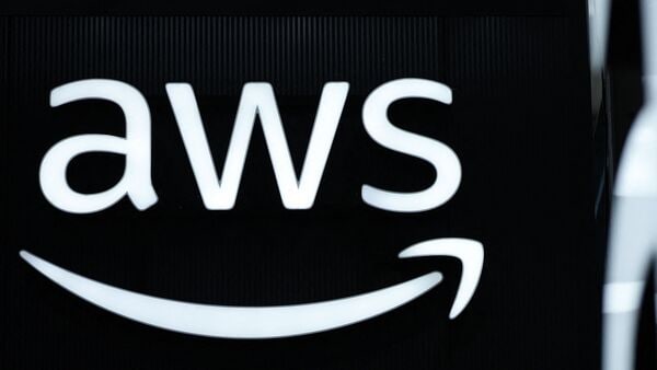 (FILES) The logo of Amazon Web Services (AWS) is seen during the opening of the Hannover Messe industrial trade fair for mechanical and electrical engineering and digital industries, on March 31, 2025 in Hanover, northern Germany. Amazon and Microsoft cloud services could face stricter EU competition rules as Brussels probes their market power, the bloc's tech chief said on November 18, 2025. (Photo by RONNY HARTMANN / AFP)