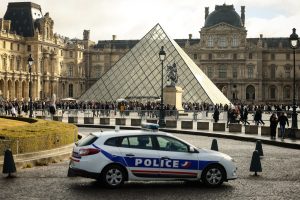 A police car outside the Louvre, one week on from the jewel heist