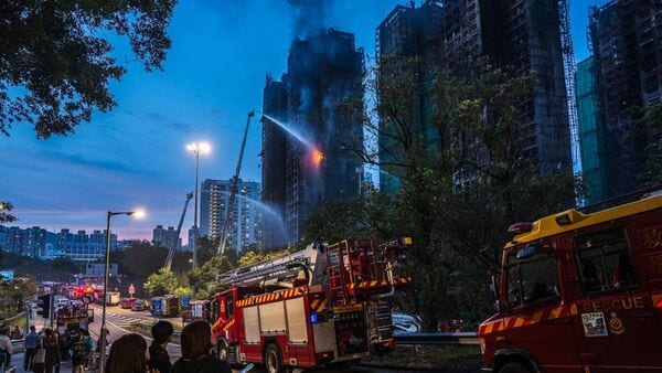 Firefighters continue to put out fires at the Wang Fuk Court residential estate in Tai Po district in Hong Kong, China, on Thursday, Nov. 27, 2025.