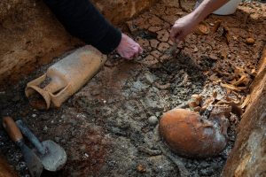 This photo released by Budapest History Museum shows researchers removing clay from an intact Roman sarcophagus at an archeological site in Budapest, Hungary, Sept. 30, 2025. (Gabor Lakos, Budapest History Museum via AP)