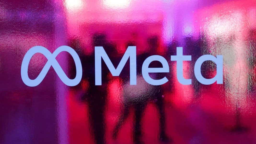 People walk behind a logo of Meta Platforms company, during a conference in Mumbai, India, September 20, 2023. Representational Image/Reuters
