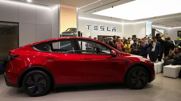Media personnel take pictures and videos of the TESLA Model Y car at India's first Tesla showroom in Mumbai, India, July 15, 2025. REUTERS/Francis Mascarenhas