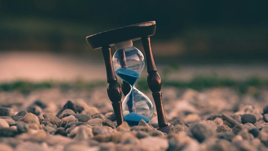 At its heart, any clock is a physical system that evolves in a predictable way, creating a record of the passage of time. An hourglass does that by accumulating grains in one vessel after moving them out of another. | Photo Credit: Aron Visuals/Unsplash