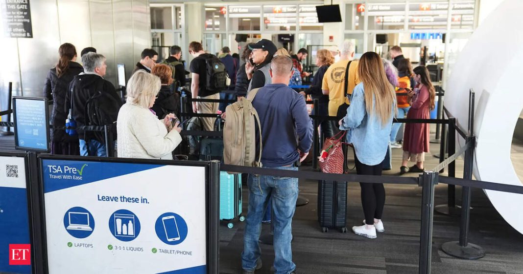 Amid shutdown-induced chaos, travelers stand in line in a TSA screening area at Philadelphia International Airport in Philadelphia.