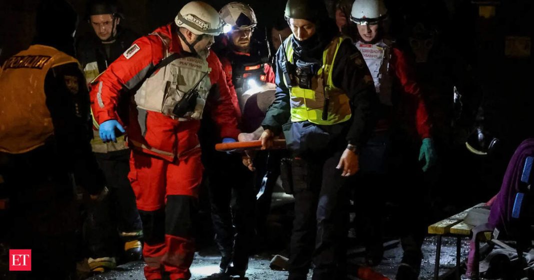 Rescuers evacuate an injured resident from an apartment building hit during an overnight Russian drone and missile strike, amid Russia's attack on Ukraine, in Kyiv, Ukraine