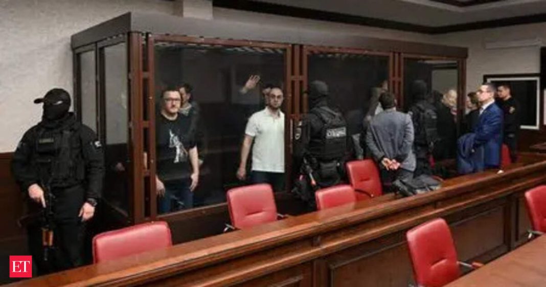 Defendants, who are accused of involvement in the bomb attack on the Crimean Bridge in October 2022 amid the Russia-Ukraine military conflict, stand behind a glass enclosure during a court hearing in Rostov-on-Don, Russia, November 27, 2025.