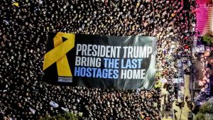 Participants hold a large banner during a rally held by hostage families and supporters at "Hostages Square" in Tel Aviv, Israel, on Oct. 18, 2025. (Ilan Rosenberg/Reuters)