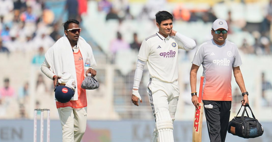 Shubman Gill, center, leaves the field after retired hurt on the second day of the first cricket test match between India and South Africa in Kolkata, India, Saturday, Nov. 15, 2025.