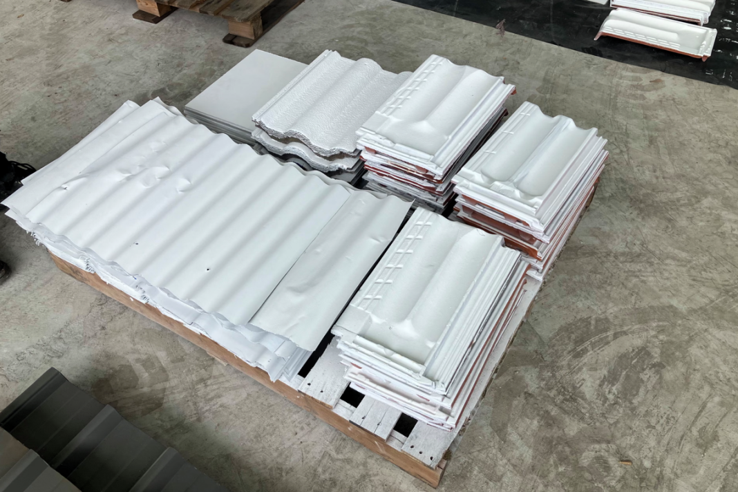 Roof tiles and steel panels coated in the new paint (University of Sydney)