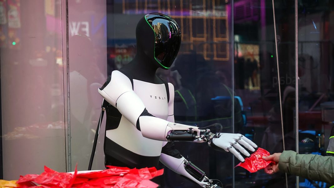 A Tesla Optimus robot hands out candy in front of the Nasdaq MarketSite in New York, US, on Monday, Oct. 27, 2025.