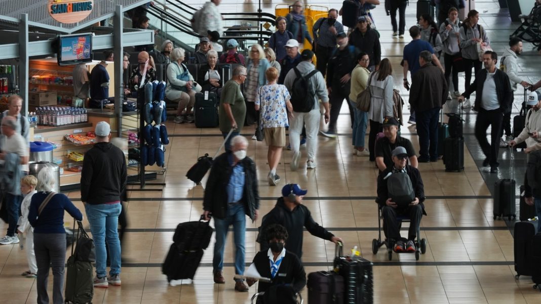 People make their way through a terminal at San Diego International Airport in San Diego. (AP Photo)