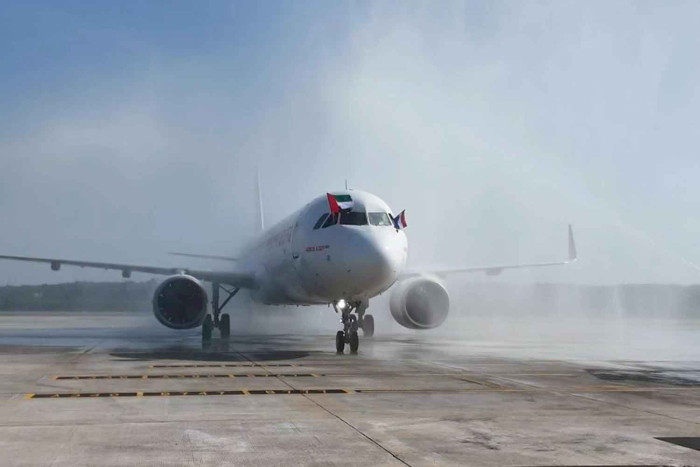 Air Arabia's pilots wave the UAE flag from the cockpit as the flight from Sharjah made its initial landing in Krabi, where it was greeted with a water cannon salute.