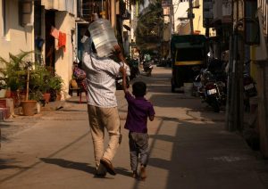 A man carries a container with filtered water filled at a government-run water vending machine. (Photo: Reuters)