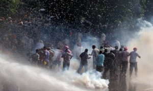 Police use teargas and water cannons to disperse protestors in Chandigarh, Punjab. (Photo: Reuters)