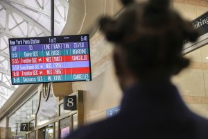 A screen displays information about trains cancelled due to a winter storm. (Photo: Reuters)