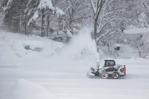 A snowplow clears a road as snow falls during the winter storm. (Photo: Reuters)
