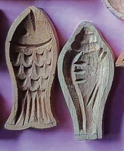 Wooden sandesh moulds in the shapes of a fish and a conch shell.