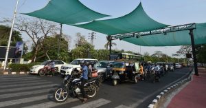 People under a cover of tarpaulin to protect commuters from summer heat in Bhubaneswar, India. (Photo: Reuters)