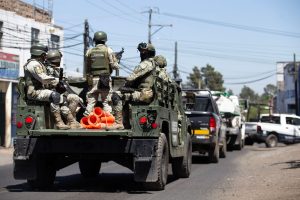 Members of the Mexican Army patrol the Morelia Patzcuaro Highway to prevent vehicle fires and road blockades in Michoacan state, Mexico, on February 23, 2026.