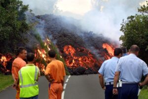 Police and security watch as lava from the volcano blocks main island road RN2. (Photo: Reuters)
