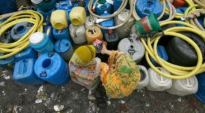 Residents surrounded by empty water containers. (Photo: Reuters)